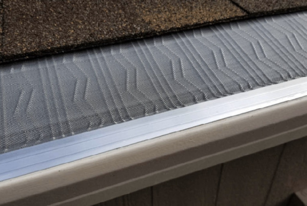 Stainless steel Leaf Blaster micro-mesh guard fitted to a gutter under shingles