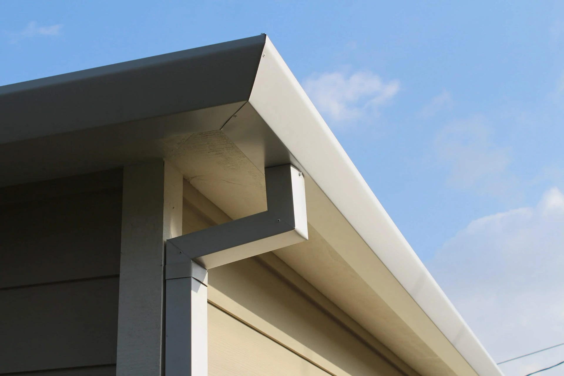 Sleek flat face gutter with a smooth minimal profile on a modern home