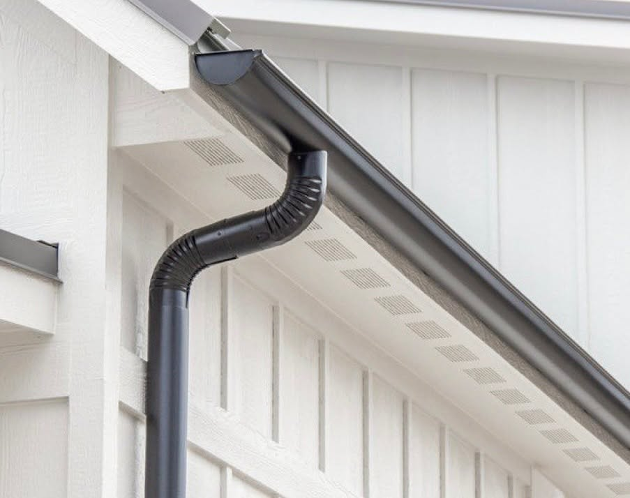 Copper half round curved gutter on a Spanish style home with tile roof