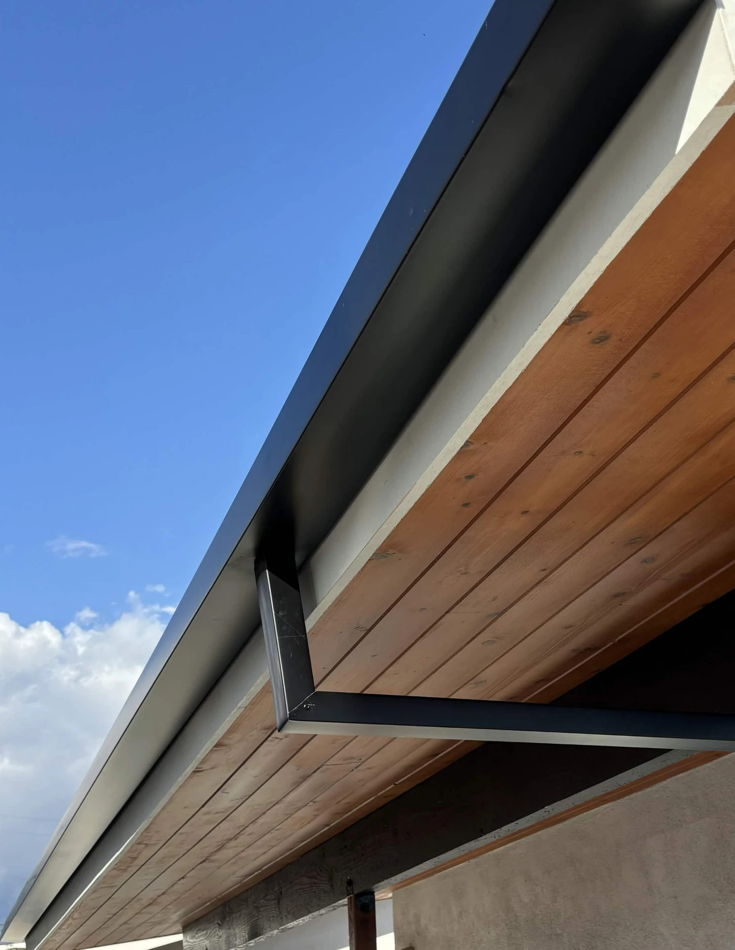 Black box style square profile gutter on a modern flat-roof home